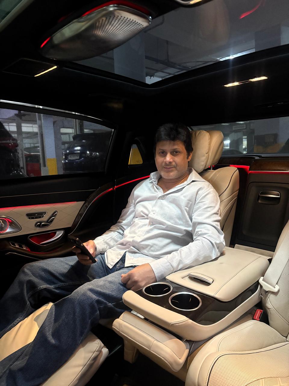 Pawan Ahuja, founder of Baba Luxury Cars, in the back seat of a luxury car